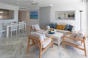 a living room with a couch and a table at Apartamentos Las Americas in Islantilla