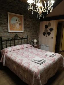 a bedroom with a large bed with two towels on it at Casa Bell in Manzanedo de Valdueza