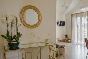 a living room with a mirror on the wall at Socrates Apartments in Skala Kefalonias