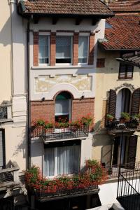 a building with flower boxes on its windows at Stresa Residence in Stresa