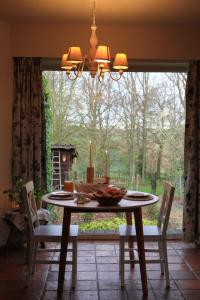 a dining room table with candles on it with a window at B&B Adem in Horebeke