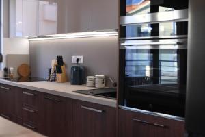 a kitchen with a stove and a microwave at Apartment Maritimo in Zadar