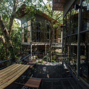 a house under construction with a deck and trees at Warehouse Hostel Koh Tao in Koh Tao