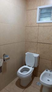 a bathroom with a toilet and a sink at Villa Ciruelos in San Rafael