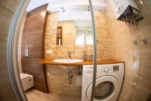 a bathroom with a sink and a washing machine at Apartament Książęcy Premium klimatyzacja 3 SYPIALNIE 3 BEDROOMS in Bolesławiec +12 photos