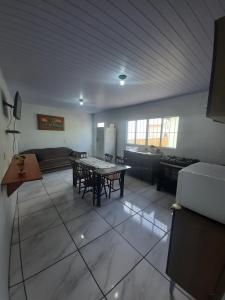 a kitchen with a table and chairs in a room at ACONCHEGO DE CANELA/RS in Canela