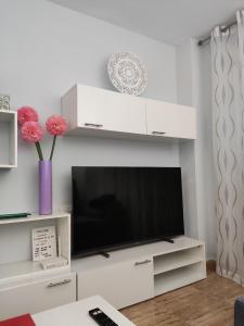 a living room with a television on a white entertainment center at La Loma de Torrevieja in Torrevieja