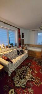 a living room with a couch and a rug at ZATOR Noclegi u Babci Józi in Zator