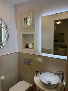 a bathroom with a toilet and a sink and a mirror at Can Xito in Sencelles