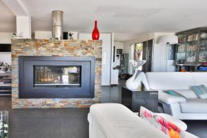 a living room with a fireplace and a white couch at Villa Louancelie B&B in Cavalaire-sur-Mer