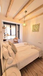 a bedroom with a large bed in a room at Apartamentos de la Huerta in Alicante