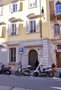 een groep scooters geparkeerd voor een gebouw bij Casa Romano Suites in Trieste