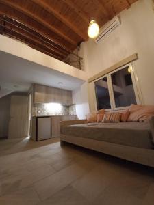 a large bedroom with a bed and a kitchen at KTIMA MORAITI - Seaside Houses in Katerini