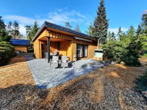 a log cabin with a patio and a stove at Ferienhaus Leon mit Sauna in Rehburg-Loccum