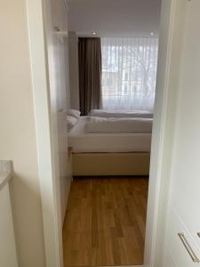 a small bedroom with a bed and a window at Zum Franziskaner Dependance in Füssen