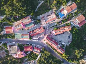 an overhead view of a group of houses and a street at Pink Palace Beach Resort in Agios Gordios