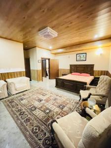a large living room with a bed and a rug at Panorama Luxury House in Nathia Gali