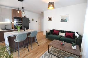 a living room with a green couch and a table at Apartment Maritimo in Zadar