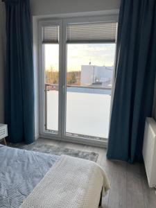 Posteľ alebo postele v izbe v ubytovaní Apartament Dziewiątka