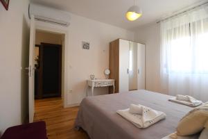 a bedroom with a bed with two towels on it at Apartment Maritimo in Zadar +8 photos