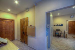 a kitchen and dining room with a table and a door at Sogni D'Oro Guest House in Florence