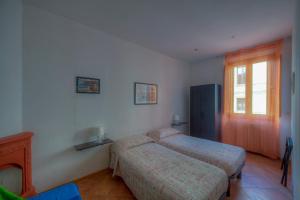 1 dormitorio con 2 camas y ventana en Sogni D'Oro Guest House, en Florencia