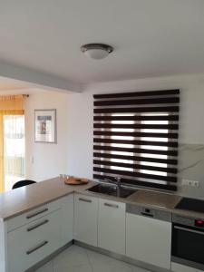 a kitchen with a sink and a window at Casa Panoramic in Turda