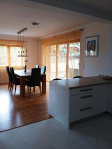 a kitchen and dining room with a table and chairs at Casa Panoramic in Turda
