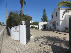 a street with a white building and a fence at Villa El Alcazar in Carvoeiro