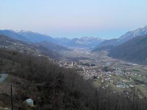 a view of a town in a valley with mountains at B&B Monte Tesobo in Roncegno