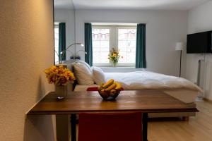 a bedroom with a bed and a table with bananas on it at River Residence in Baden