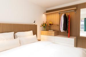 a bedroom with a bed and a wooden wall at River Residence in Baden
