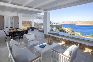 a living room with a view of the ocean at Mykonian house in Elia beach by GHH in Elia Beach