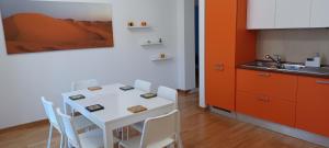 a kitchen with a white table and white chairs at Terrazza di San Paolo in Rome