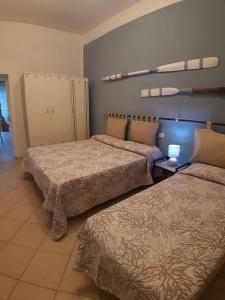 a hotel room with two beds and aezvous at Trilocale Il timone in Fetovaia