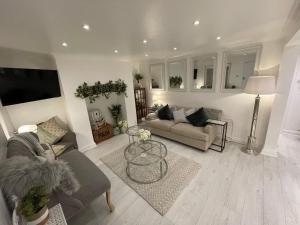 a living room with a couch and a table at Central Apartment - with Patio and Sofa Bed! in Cheltenham