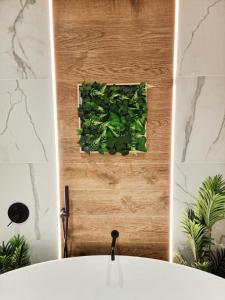 Baño con una planta verde en la pared en Holiday Home Sofia La vie est belle en Bollendorf