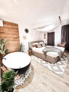 a bedroom with a bath tub and a bed at Holiday Home Sofia La vie est belle in Bollendorf