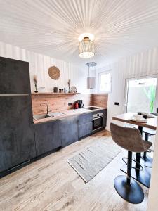 a kitchen with a sink and a table at Holiday Home Sofia La vie est belle in Bollendorf