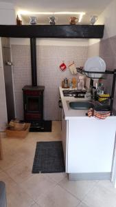 a kitchen with a stove and a stove top oven at Casa Natalia in Caoria