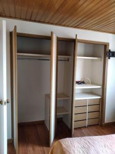 a bedroom with a closet with shelves and a bed at Mirador del parque in Bogotá