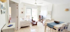 a living room with a table and a dining room at Apartamento Flamingo by DENIA COSTA in Denia