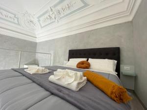 a bedroom with a bed with two towels on it at Superior Apartment Catania in Catania