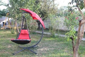 a swing in a yard with a red canopy at Karaagac Green Edirne in Edirne +27 photos