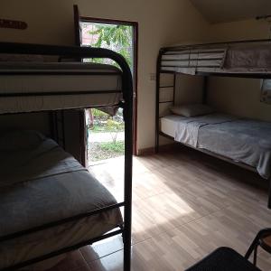 a room with two bunk beds and a window at LOS PINOS DE TORIO in Torio