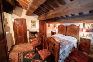 een slaapkamer met een houten bed in een kamer bij Degli Alessandri tower in Sassoferrato