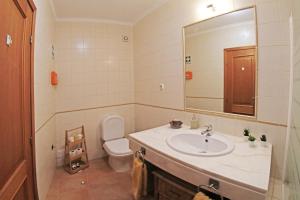 a bathroom with a sink and a toilet and a mirror at ML Central Vila Apartment in Carvoeiro +35 photos