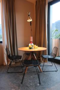 a table with chairs and a table with a cake on it at Picobello Lago in Mandello del Lario