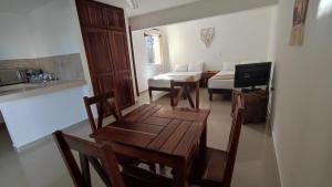 a living room with a table and chairs and a couch at Casa calendario azteca in Playa del Carmen