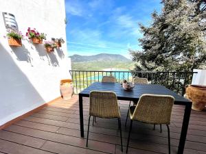 a blue table and chairs on a balcony at La Buganvilla in Zahara de la Sierra